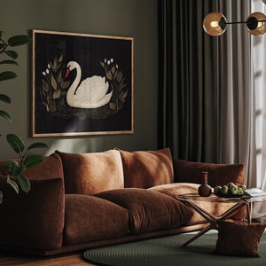 May include: A brown velvet sofa with a framed print of a white swan on a black background. The sofa is in a living room with green curtains and a glass coffee table.
