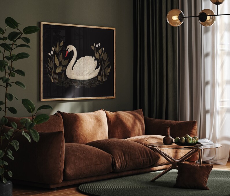 May include: A brown velvet sofa with a framed print of a white swan on a black background. The sofa is in a living room with green curtains and a glass coffee table.