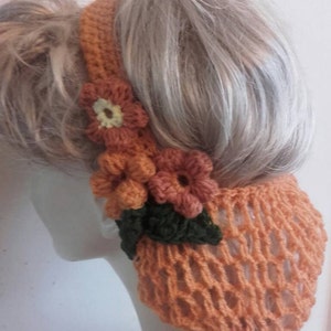 May include: A crocheted hairnet with a floral design in shades of orange and green. The hairnet is made with a delicate open weave pattern.