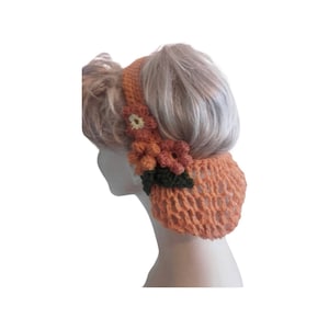 May include: A crocheted hair net with a floral design in shades of brown, green, and cream. The net is made of a fine mesh and has a headband style.
