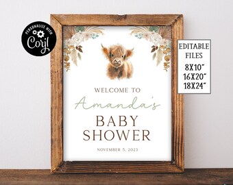 May include: A printable baby shower welcome sign featuring a cute highland cow illustration and floral accents. The sign reads "Welcome to Amanda's Baby Shower, November 5, 2023".