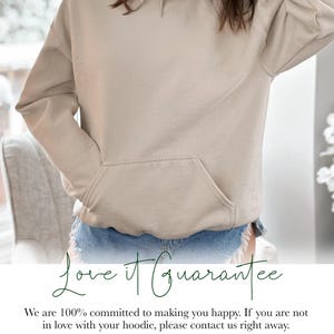 May include: A beige hoodie with a front pocket and drawstring hood. The image includes the text "Love it Guarantee" and a customer satisfaction statement.