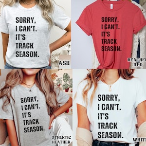 May include: Four t-shirts in different colours with the text "Sorry, I can't. It's track season." printed on them. The colours are ash, heather red, athletic heather, and white.