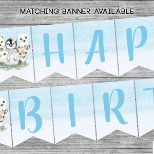May include: A blue and white banner with the words "Happy Birthday" in blue letters. The banner features a wintery design with snowflakes and a watercolor background. The banner is decorated with cute animal illustrations, including an owl, a penguin, a deer, and a polar bear.