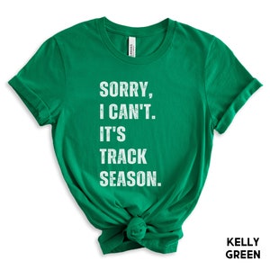May include: A kelly green t-shirt with the text "Sorry, I can't. It's track season." in white.
