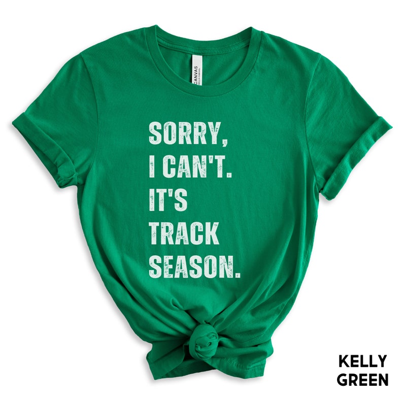 May include: A kelly green t-shirt with the text "Sorry, I can't. It's track season." in white.
