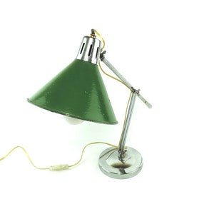 May include: A vintage green and chrome desk lamp with an adjustable arm. The lamp has a cone-shaped shade and a round base.