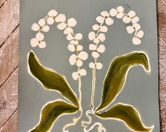 May include: A painting on a sage green background featuring two stems of white lily of the valley flowers with small yellow centers and dark olive green leaves. The stems have white outlines and a signature is visible in the bottom right corner.