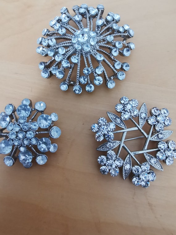 Three silver tone brooches with clear stones - image 1