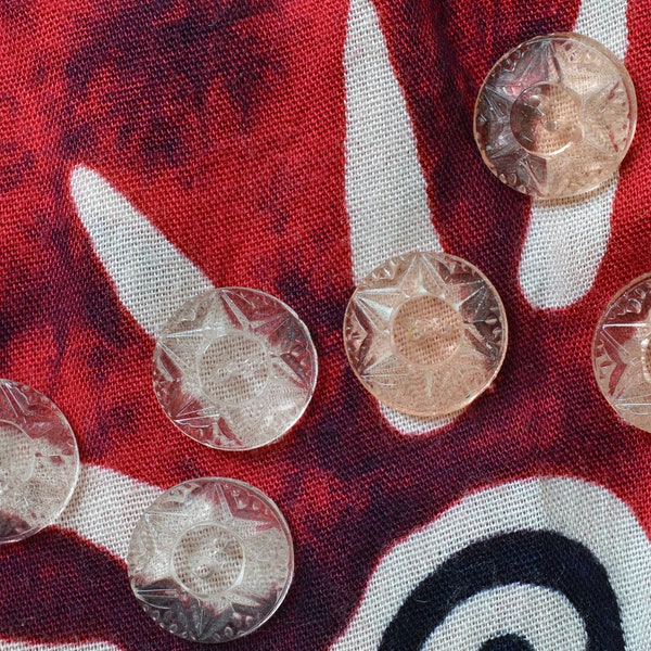 Set of ten glass buttons with star flower shape detail pressed onto face. Two colors available, light peach and super light pink color.20mm