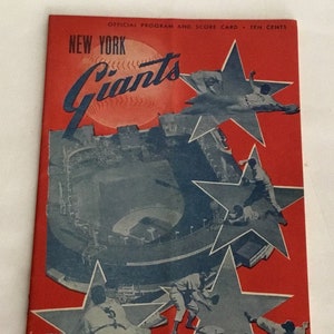 May include: A vintage New York Giants baseball program from 1949. The cover features a red background with a blue and white image of the Polo Grounds stadium and five blue stars with baseball players in each star. The text "NEW YORK Giants" is in white and red lettering. The text "POLO GROUNDS 1949" is in white lettering.