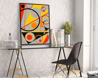 May include: A black framed abstract art print with geometric shapes in yellow, orange, red, and gray. The print is hanging on a white wall above a glass-top desk with a black chair.
