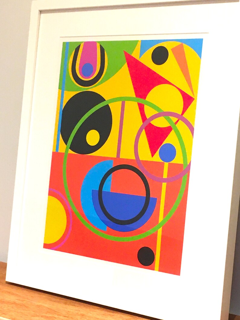 May include: Abstract geometric art print featuring a red, yellow, green, blue, and black color scheme. The print features circles, semi-circles, triangles, and lines.