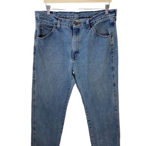 May include: A pair of light blue denim jeans with a classic five-pocket style. The jeans have a straight leg and a relaxed fit.