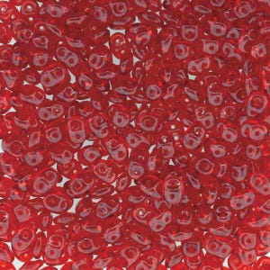 May include: A close-up view of a large quantity of small, red, glass beads. The beads are shaped like teardrops with a small hole at the top.