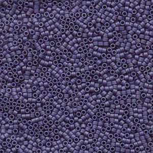 May include: A close-up view of a large quantity of small, round, purple beads. The beads are all the same size and shape, and they are arranged in a random pattern.