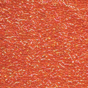 May include: A close-up image of a large quantity of small, round, orange seed beads. The beads have an iridescent finish, which gives them a shimmering effect.
