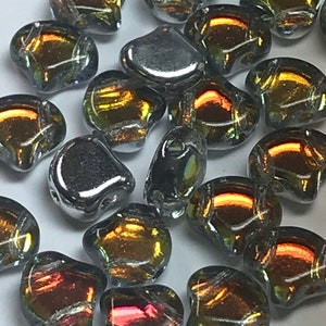 May include: A collection of iridescent glass beads in shades of silver, gold, and bronze. The beads are shaped like teardrops and have a smooth, polished finish.