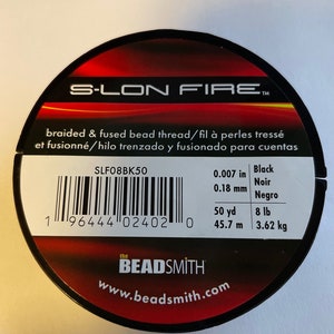 May include: A spool of black S-LON FIRE braided and fused bead thread. The label reads "braided & fused bead thread/fil à perles tressé et fusionné/hilo trenzado y fusionado para cuentas". The spool is 50 yards (45.7 meters) long and weighs 8 pounds (3.62 kilograms).