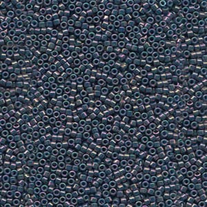 May include: A close-up view of a large quantity of small, dark blue, iridescent glass beads. The beads are cube-shaped and have a metallic sheen.
