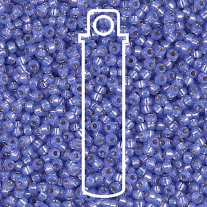 May include: A close-up of a pile of small, round, blue seed beads. The beads have a shiny, metallic finish and are scattered across the image. A white outline of a bottle is superimposed over the beads.