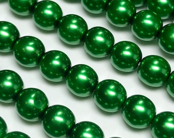 May include: A strand of green pearl beads. The beads are round and have a high gloss finish.