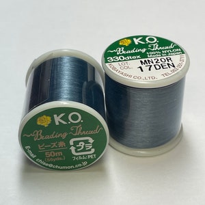 May include: Two spools of blue nylon beading thread. The spools are labeled "K.O. Beading Thread 330dtex 100% Nylon Made in Japan MN20R 17DEN LOT. COL. KOBAYASHI CO., LTD. TEL. 052-251-3711" and "K.O. Beading Thread ビーズ糸 プラ 50m (55yds.) フィルム: PET chiose@chumon.co.jp".