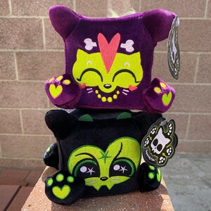 Hex & Jinxy Cats GLOW in the DARK plushies, the weird and cute plush witch cat and voodoo cat plush mashups by Squaredy Cats. They Glow!