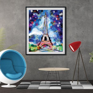 May include: A framed abstract painting of the Eiffel Tower in Paris, France. The painting is done in a colorful style with blue, pink, and green hues. The background is a dark blue with white stars.