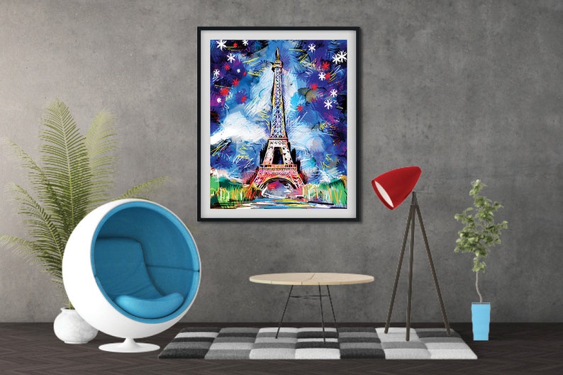 May include: A framed abstract painting of the Eiffel Tower in Paris, France. The painting is done in a colorful style with blue, pink, and green hues. The background is a dark blue with white stars.