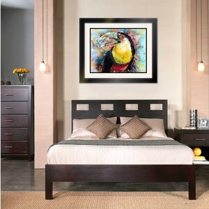 May include: A dark wood bed frame with a headboard featuring a geometric design. The bed is made with white linens and two brown throw pillows. A framed painting of a toucan with a colorful background hangs on the wall above the bed.