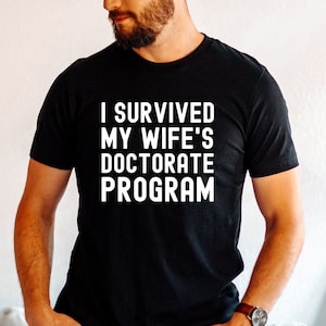 I Survived My Wife's Doctorate Program Shirt, Doctorate Shirt, Funny PHD Graduation Gift, PHD Tee, Sarcastic Gift for PhD Husband, Graduate