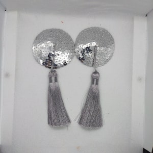 May include: A pair of silver sequin pasties with gray tassel accents.