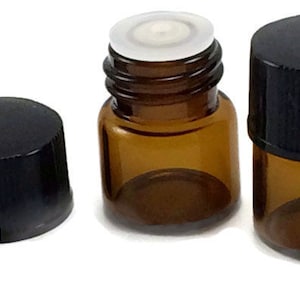 May include: Three amber glass bottles with black screw-on caps and white plastic droppers. The bottles are small and cylindrical.