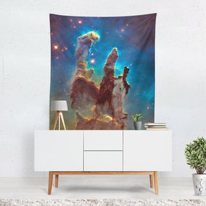 May include: A tapestry featuring a vibrant depiction of the Eagle Nebula's Pillars of Creation. The image showcases towering, reddish-brown formations against a backdrop of blue and gold cosmic dust and stars, creating a celestial scene.