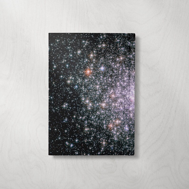May include: A black and white photograph of a star cluster with thousands of stars visible. The stars are of varying sizes and brightness, creating a beautiful and intricate pattern.