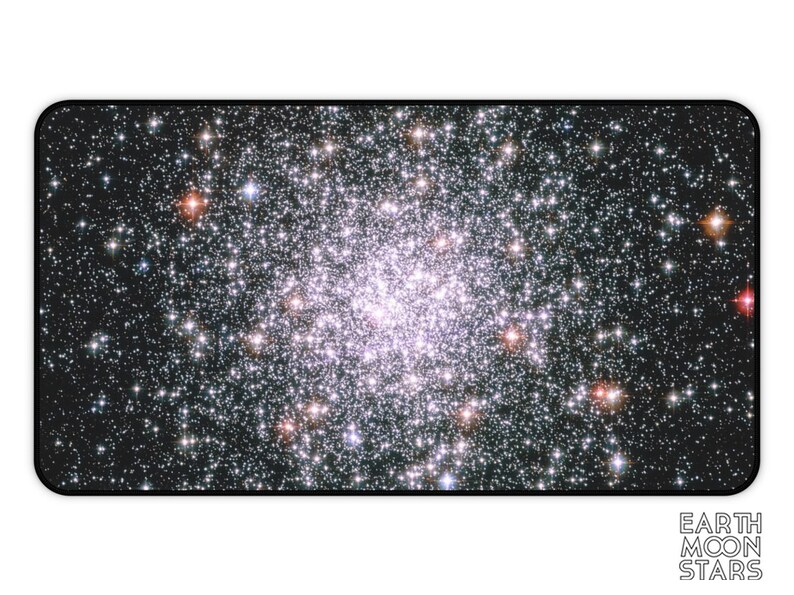 May include: Rectangular mousepad featuring a vibrant image of a star cluster against a dark background. The image has a concentration of bright, white stars in the center, with some reddish-orange stars scattered throughout. The words "EARTH MOON STARS" are in white text at the bottom.