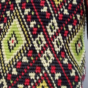 Close up of colorful tapestry crochet pattern on handmade Ukrainian folk shoulder bag.