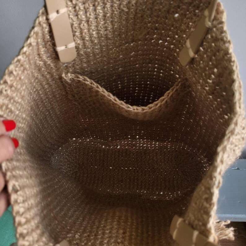 Inside view of the large jute crochet tote showing the interior pocket and roomy open compartment.