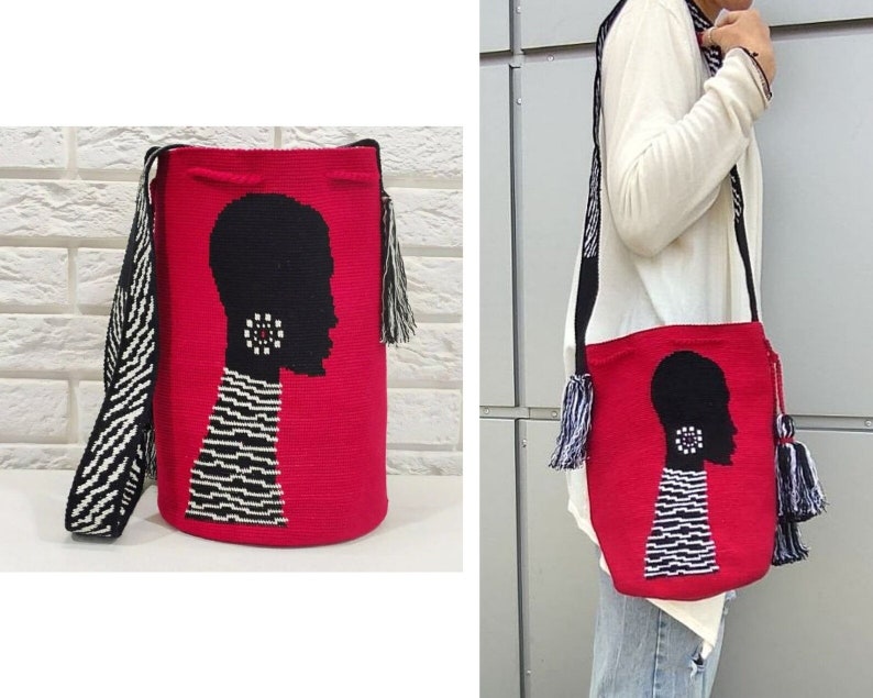 May include: A red woven bag with a black and white silhouette of a person's head with a large earring. The bag has a black and white striped strap and black and white tassels.