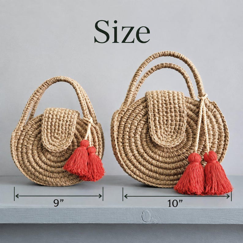 May include: Two round, crocheted jute handbags with top handles and flap closures. Each bag features a pair of red tassels attached to the handle. The smaller bag measures 9 inches in width, and the larger bag measures 10 inches in width.