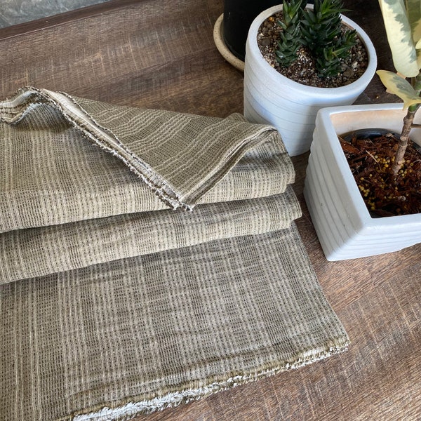 Olive shade ,The Chiangmai cotton woven,natural cotton with black dot threads and white line slight pattern,soft ,cotton woven sell by yards