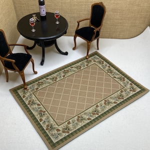 May include: A brown and green area rug with a diamond pattern and a pine cone border. The rug is on a white surface with two black chairs and a black table with wine glasses.