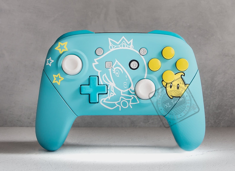 The image showcases a blue princess rosalina video game controller. It features a variety of buttons, including a blue directional pad. There are also yellow A, B, X, and Y buttons which are the action buttons on the controller.