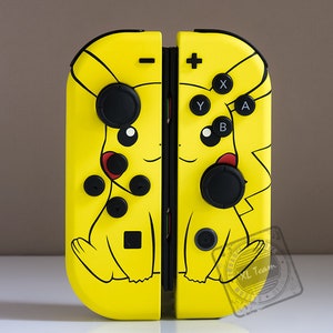 May include: A yellow Nintendo Switch Joy-Con controller with a Pikachu design. The controller has black buttons and a black joystick.
