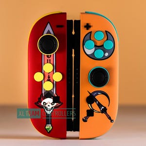 May include: Custom Switch Joy-Con controllers with a red and orange design. The left controller has a sword and skull graphic, while the right features a crescent blade. Both controllers have black buttons and yellow accents. The text "XL TEAM CONTROLLERS" is visible.