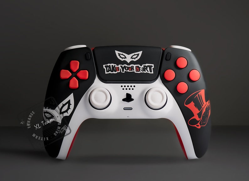 May include: A custom black, white, and red PlayStation 5 controller. The controller features a design inspired by the video game Persona 5, with the text "TAKE YOUR HEART" and a mask graphic.