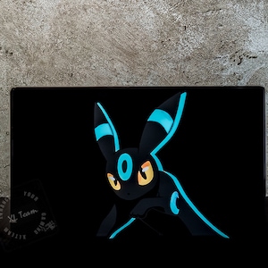 Könnte beinhalten: Ein schwarzer und blauer Pokémon-Charakter mit einem großen, weißen Auge vor einem schwarzen Hintergrund.