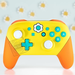 May include: A yellow and orange Nintendo Switch controller with a white daisy design and turquoise buttons. The controller has a white button on the left and right sides.