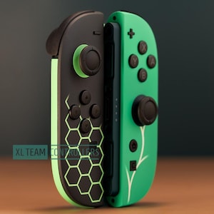 May include: Two-piece gaming controller set. One side is black with a green honeycomb pattern, the other is green with white floral accents. The controllers have black buttons and joysticks. The text "XL TEAM CONTROLLERS" is visible.
